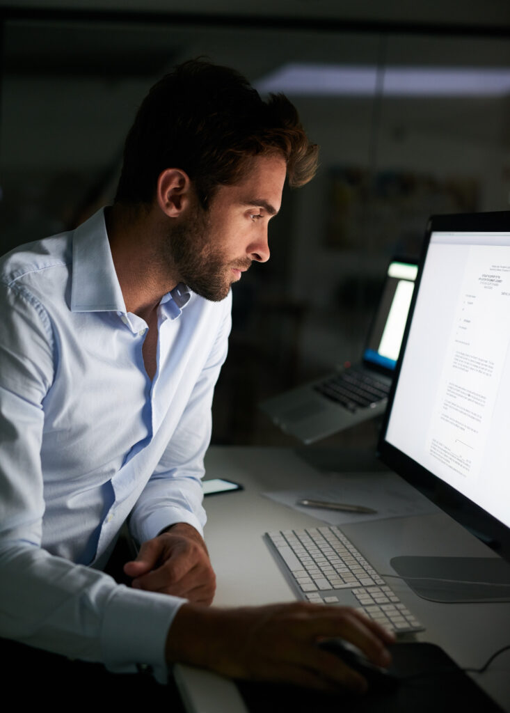 Putting in the hours to achieve success. Shot of a young businessman working late at the office. Shot of a young businessman working late at the office.